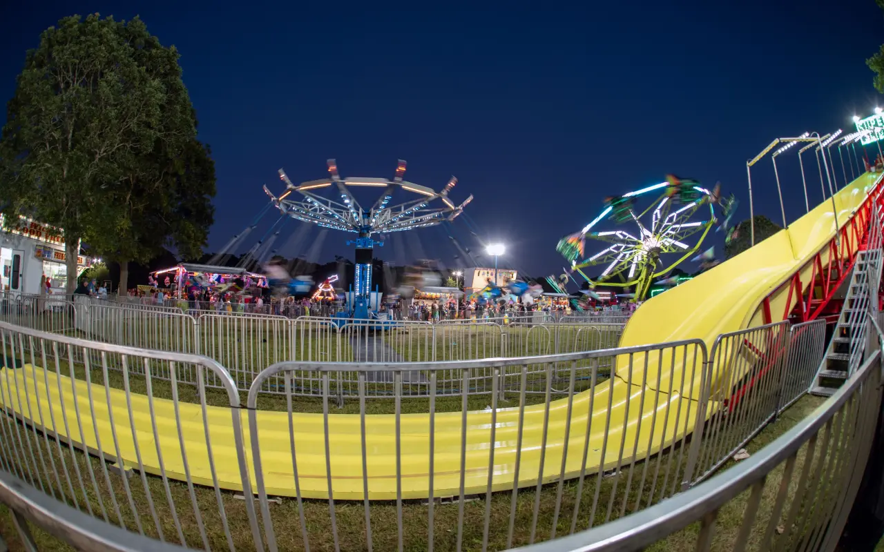 Carnival rides lit up at night on the Martha’s Vineyard Agricultural Fair midway