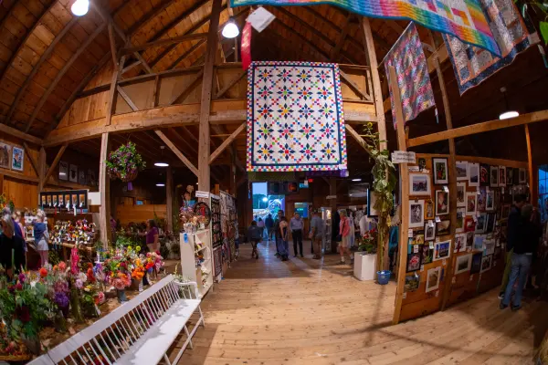 Handmade quilts and flower entries inside the Ag Hall