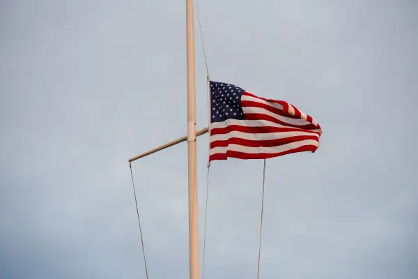 A flag lowered on a yardarm mast.