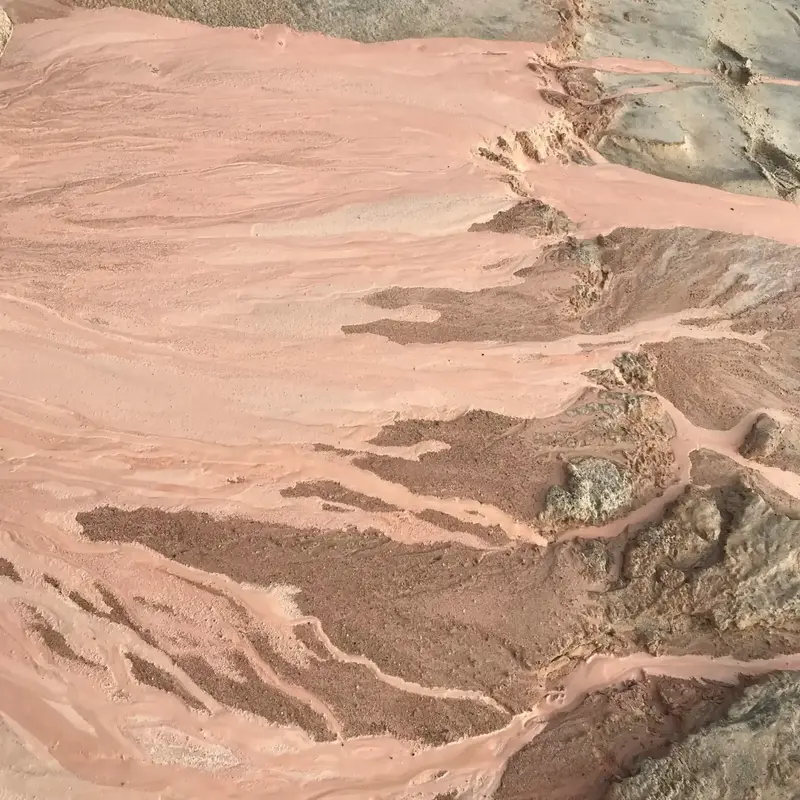 Pink and grey clay washed smooth by erosion