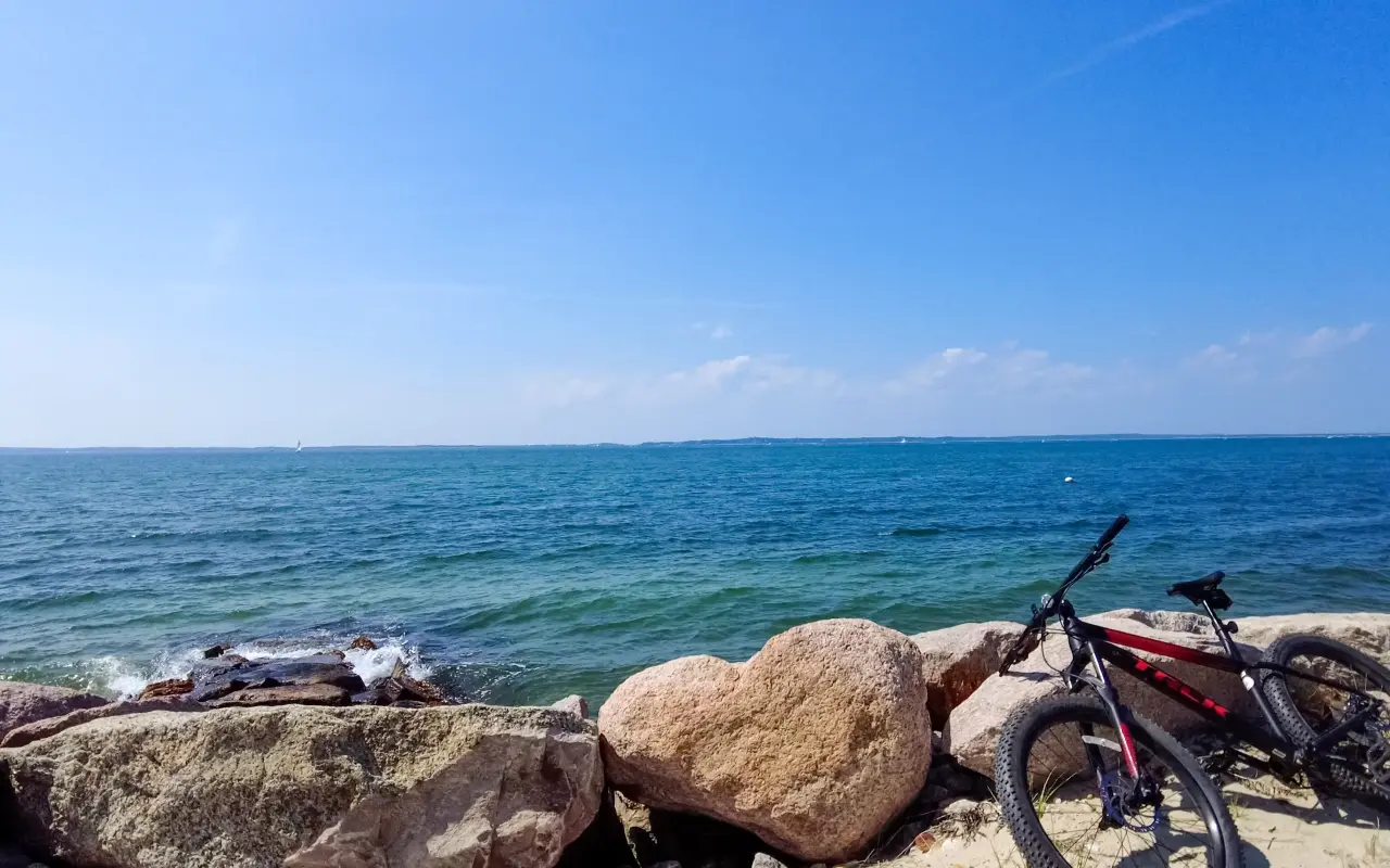 Bicycle leaning on rocks at the shoreline on Martha’s Vineyard