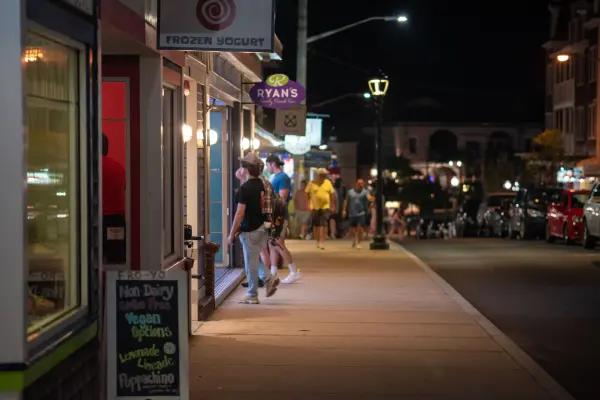 Evening strollers passing shops along Circuit Avenue