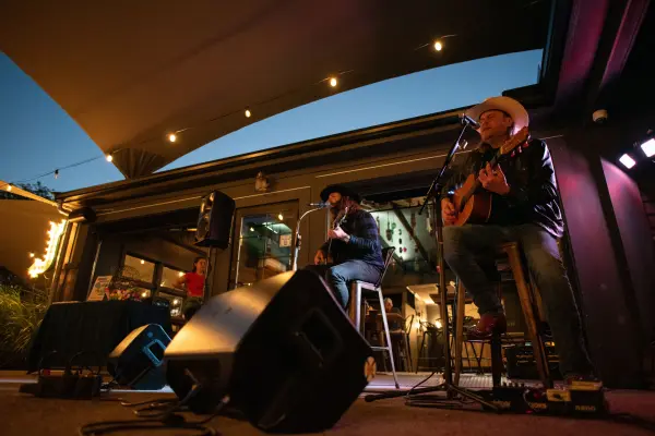 CJ Solar and Rick Huckaby performing under the Nomans patio lights