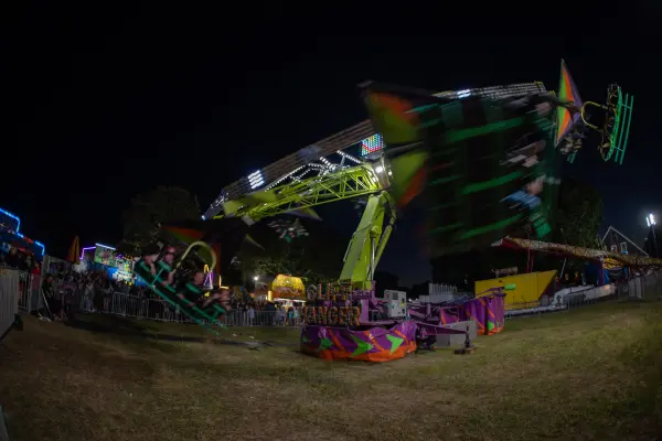 Cliff Hanger ride spinning at night at the Ag Fair