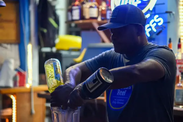 Bartender mixing a dirty banana cocktail at Donovans Reef