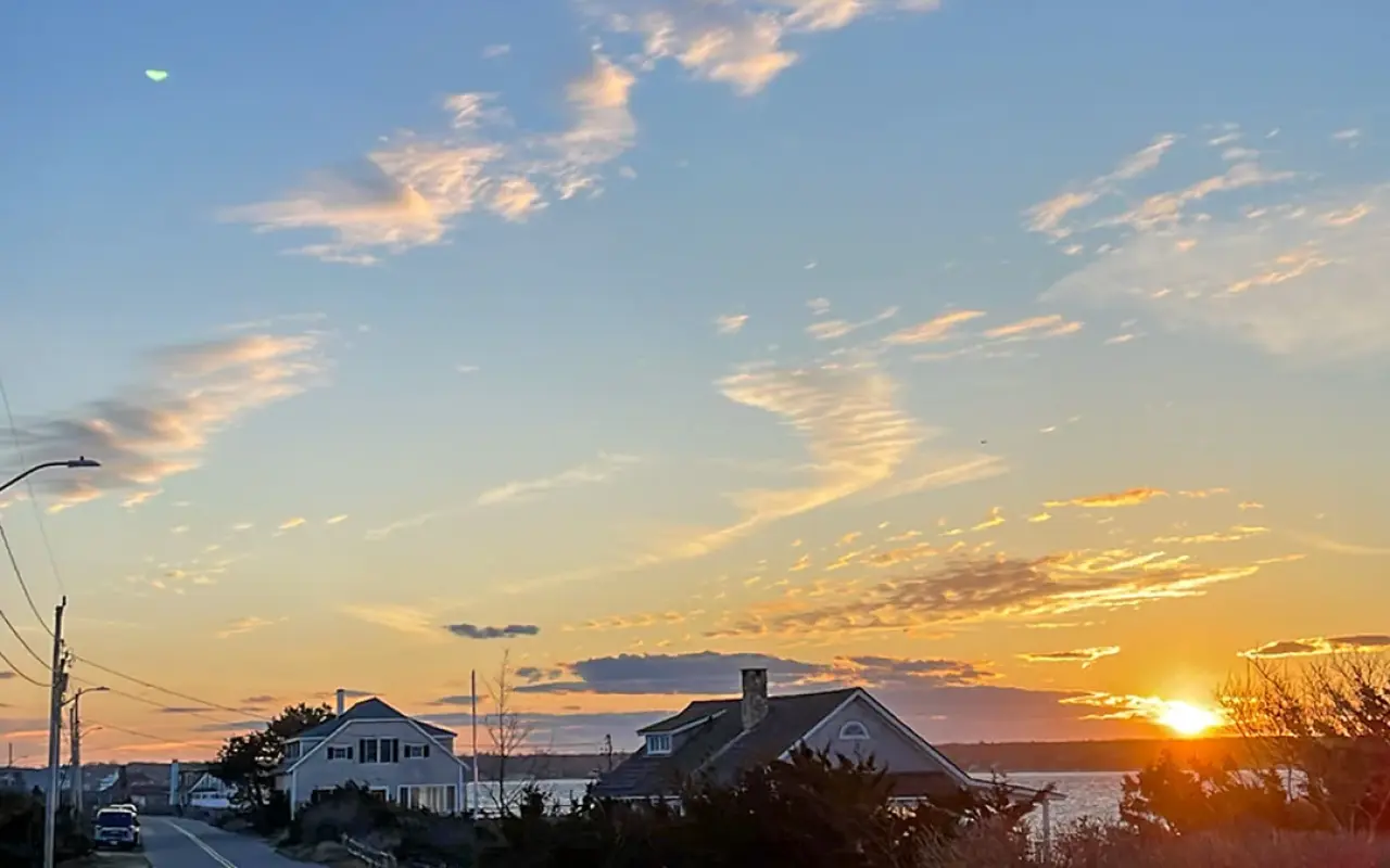 East Chop Drive in Oak Bluffs at sunset with the sky glowing orange over the water