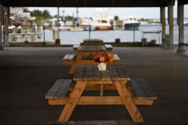 Picnic tables under the Memorial Wharf pavilion