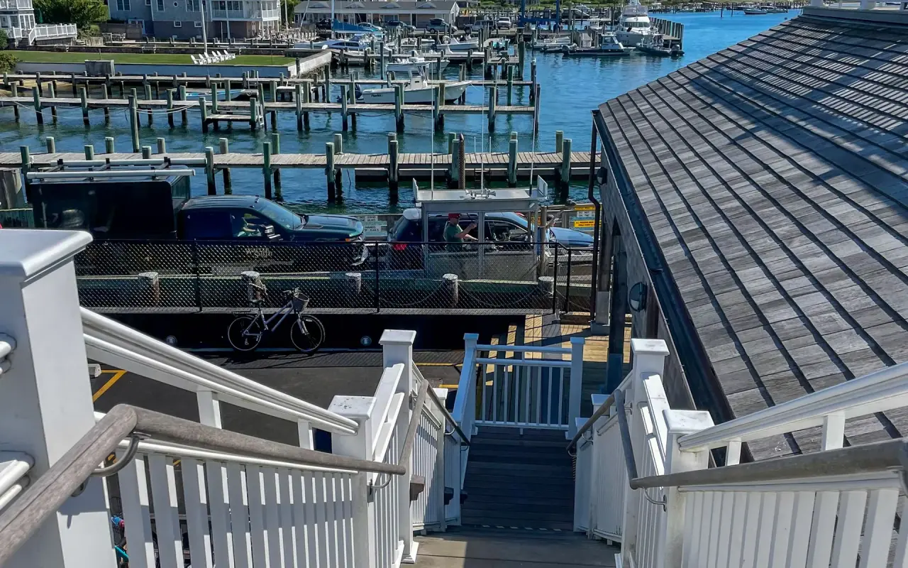 View down the stairs to the Chappaquiddick ferry slip and Edgartown harbor with moored boats