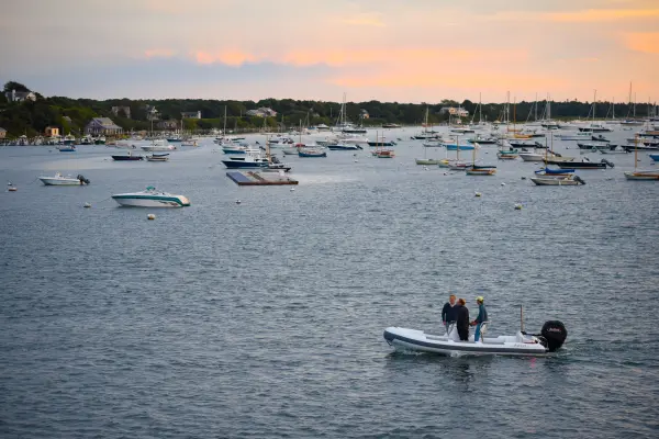 Skiff heading out among moored boats, Edgartown Harbor