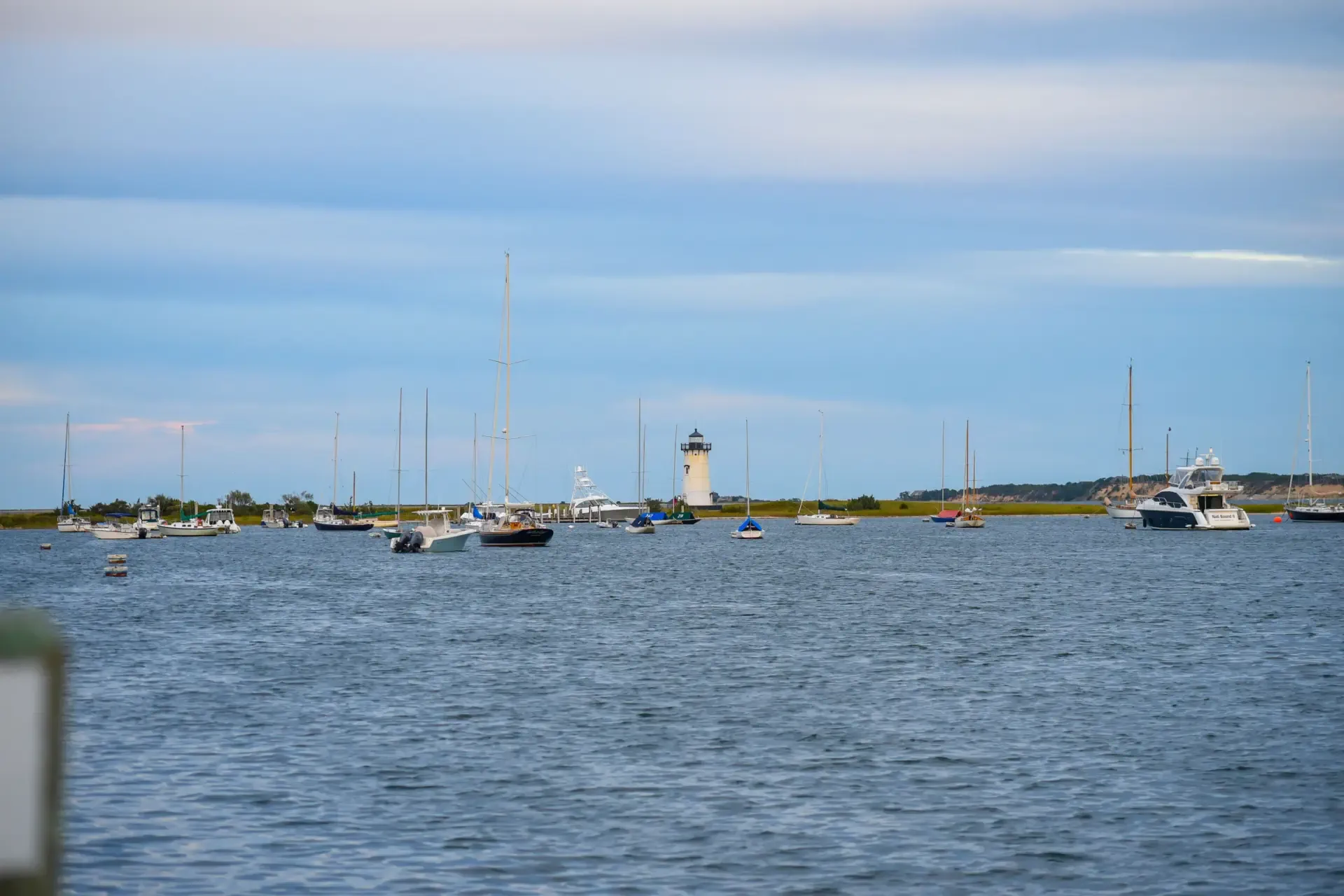 Edgartown Harbor Light with sailboats at anchor