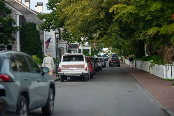 Cars parked along a leafy residential street in Edgartown
