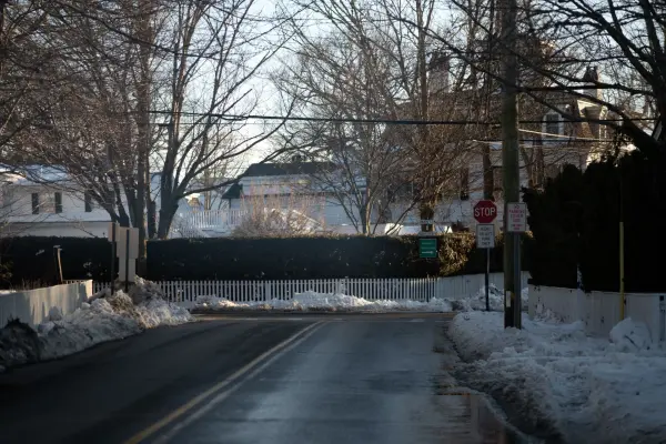 Quiet Edgartown street with hedges and melting snow