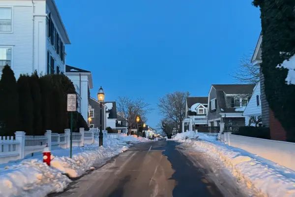 Snowbanks line a quiet Edgartown street at dusk