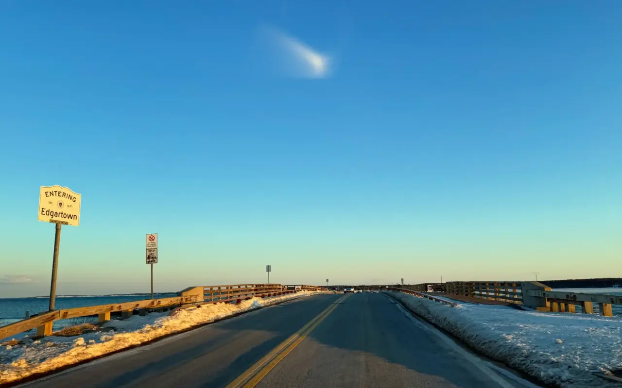 Jaws Bridge road view in winter with the Entering Edgartown sign and snow banks