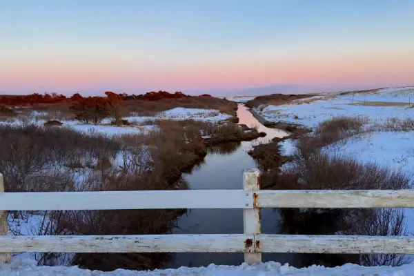 Pastel winter dusk over the marsh creek at Katama