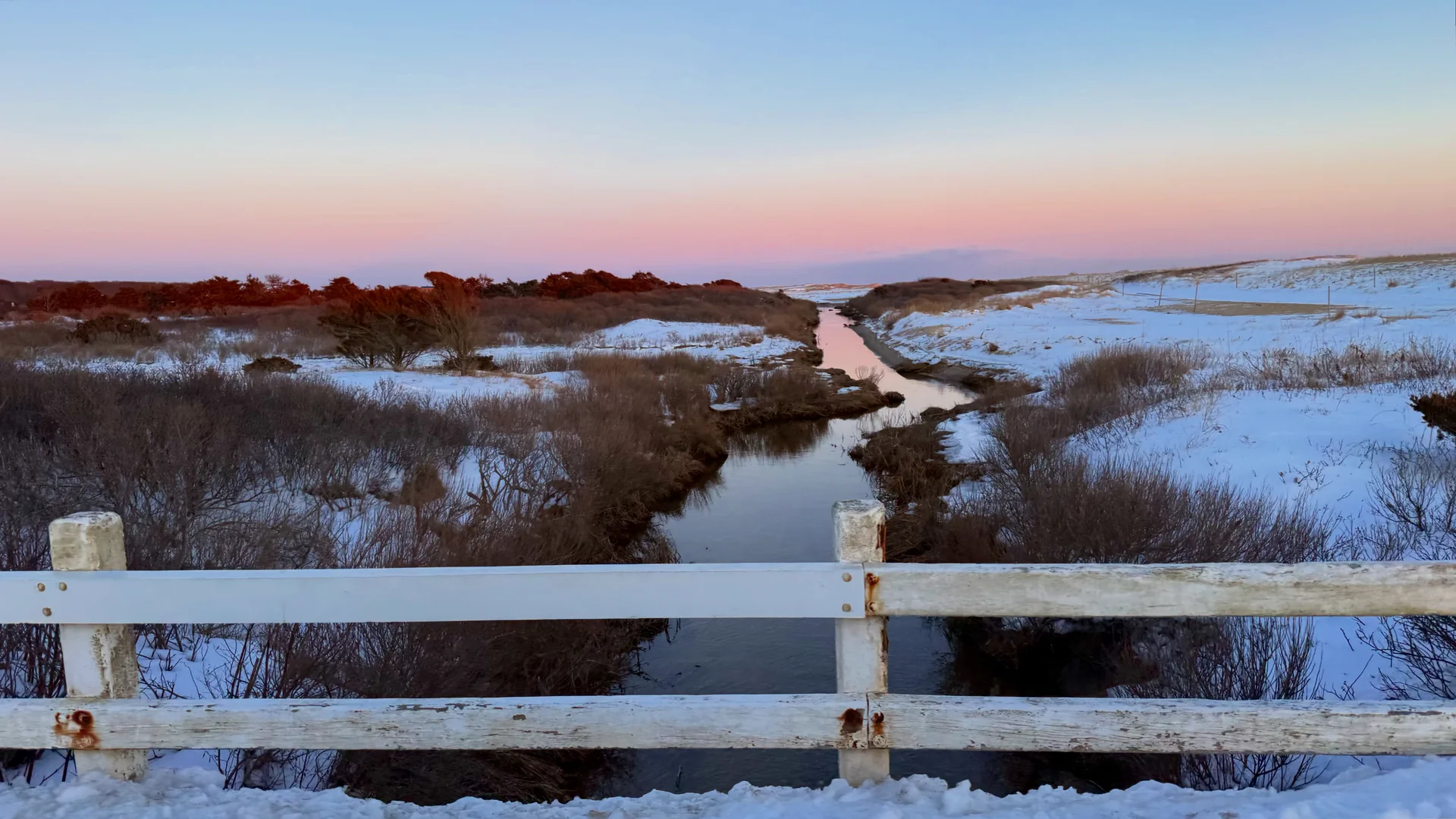 Pastel winter dusk over the marsh creek at Katama