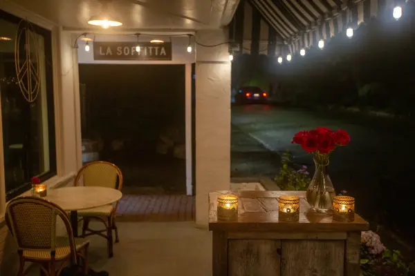 La Soffitta entrance at night, candles on the table
