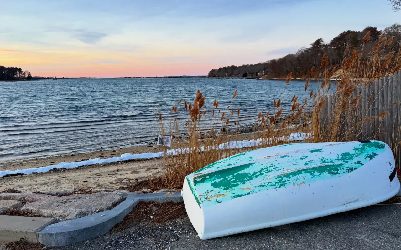 Overturned dinghy beside Lake Tashmoo on a winter evening
