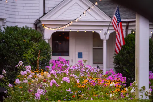 Flower beds and string lights outside L'etoile restaurant
