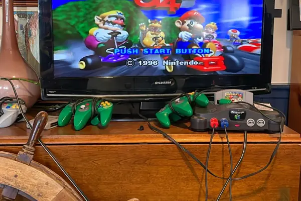 Mario Kart 64 set up under the Holy Ghost banner at the PA Club.