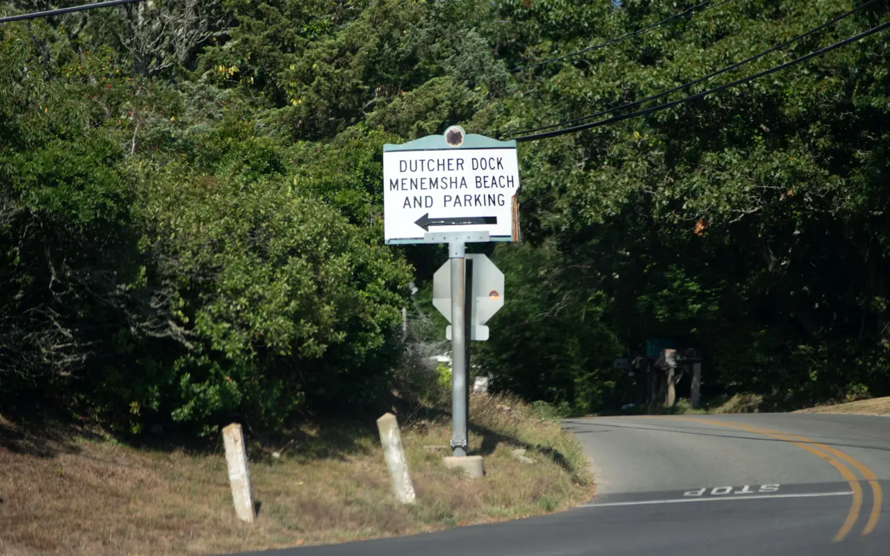 Road sign pointing to Dutcher Dock, Menemsha Beach and parking in Chilmark