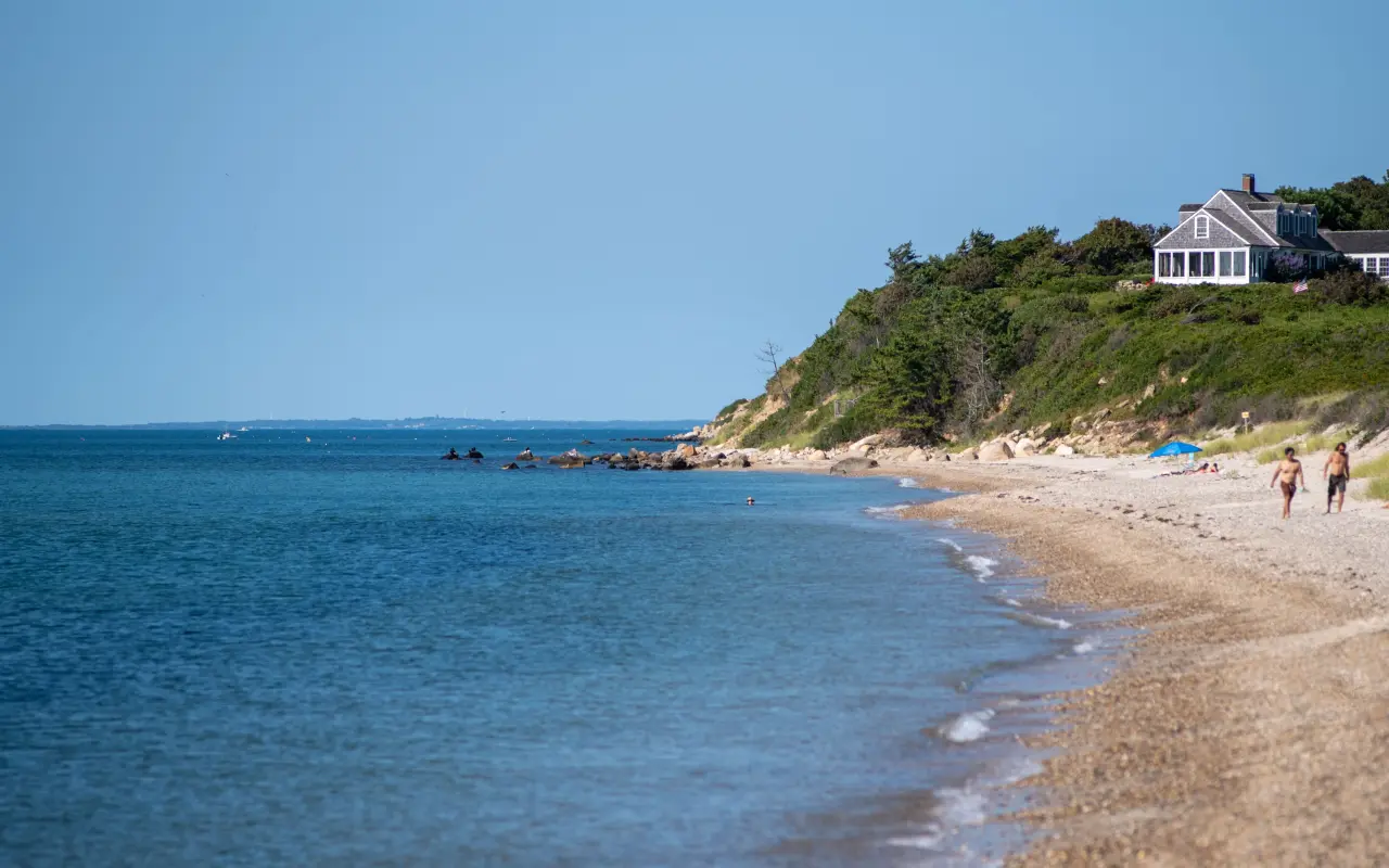 A swimmer in flat Sound water below the bluff at Menemsha