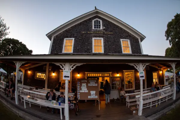 MV Agricultural Society hall porch at dusk during the fair