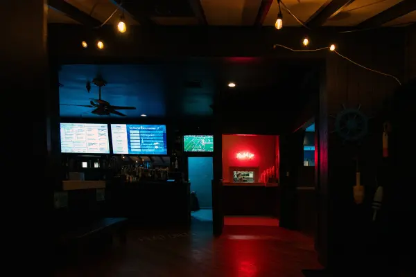 Inside the dimly lit Nomans bar with TV screens