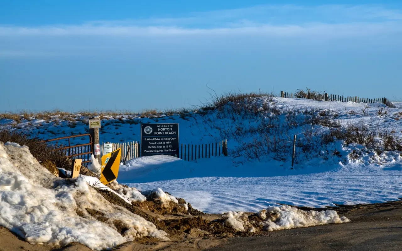 Closed sign and snow at the Norton Point over-sand entrance in February 2026