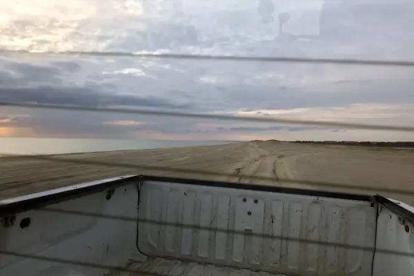 Looking over a pickup bed onto the sand at Norton Point