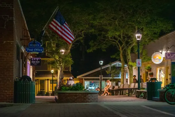 Downtown Oak Bluffs at night with American flag and post office sign