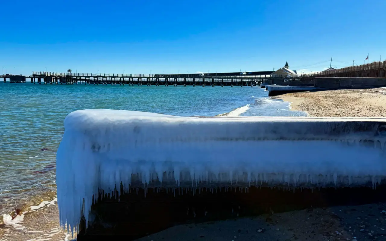 Ice-covered seawall in Oak Bluffs with the ferry pier in the background