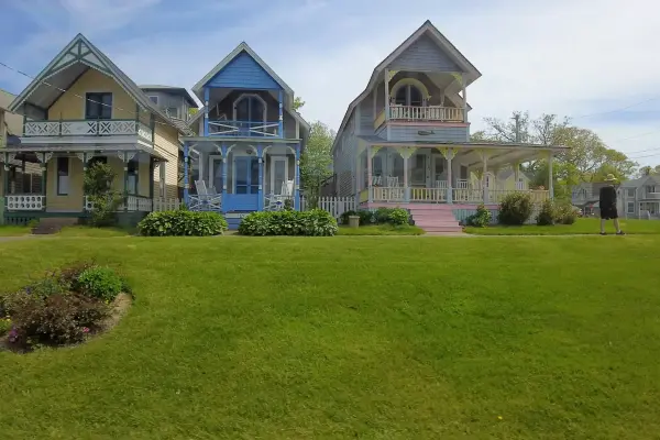 Colorful gingerbread cottages facing the green in the Campground
