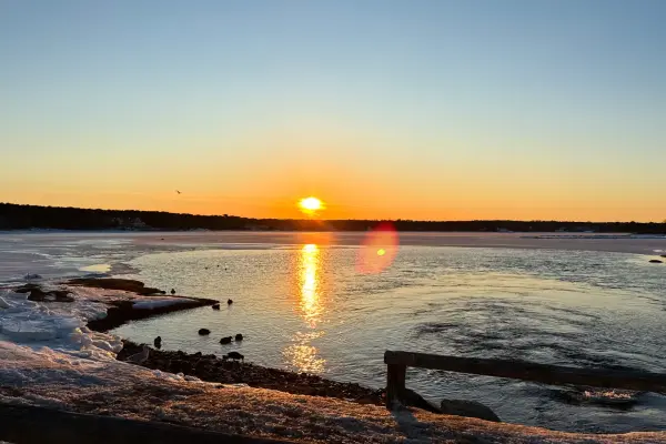 Low winter sun over a frozen Oak Bluffs harbor