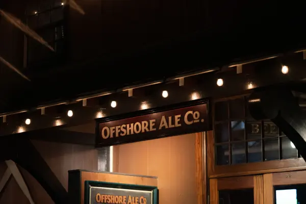 Offshore Ale Co. sign above the entrance under string lights