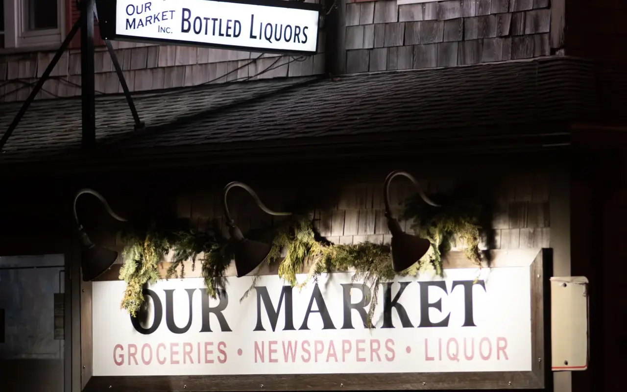 Our Market signs in Oak Bluffs listing groceries, newspapers and liquor