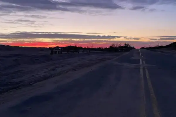 Fiery sunset over the dunes along the road to South Beach