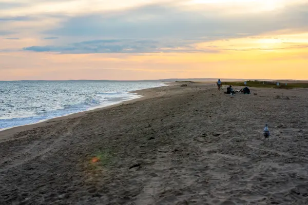 Sunset glow over the shoreline at South Beach with a few beachgoers