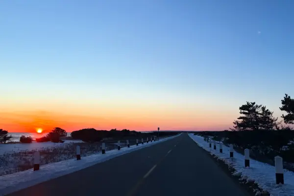 Winter sunset over the snow-edged road to South Beach