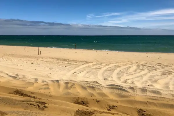 Volleyball net strung on the empty sand at South Beach