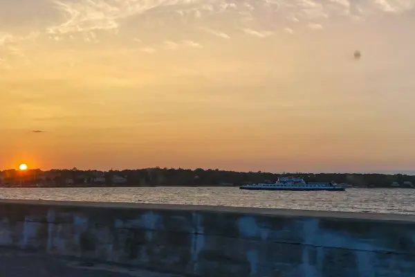 Ferry passing at sunset seen from the bridge