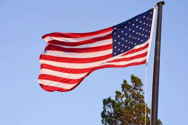 American flag waving against a clear blue sky