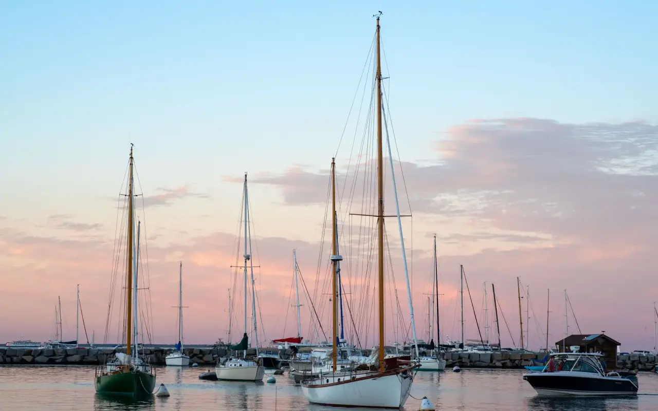 Sailboats moored in Vineyard Haven Harbor at sunset