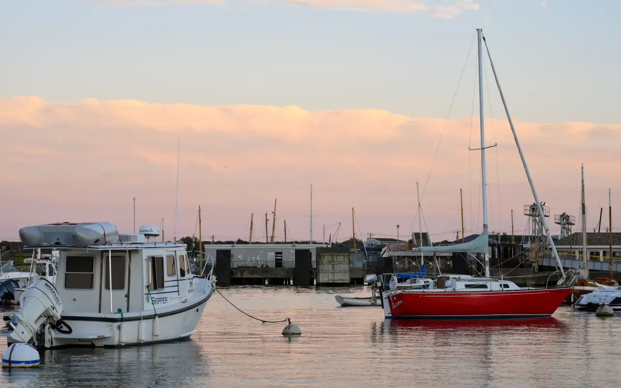 Sailboats moored in Vineyard Haven Harbor at dusk