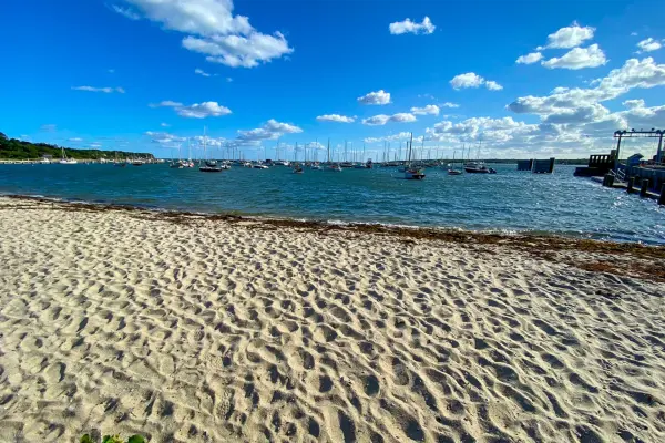 Sandy beach at Vineyard Haven Harbor with sailboats offshore