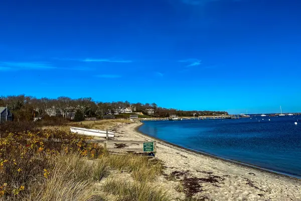 Quiet harbor beach with a small skiff ashore in late fall