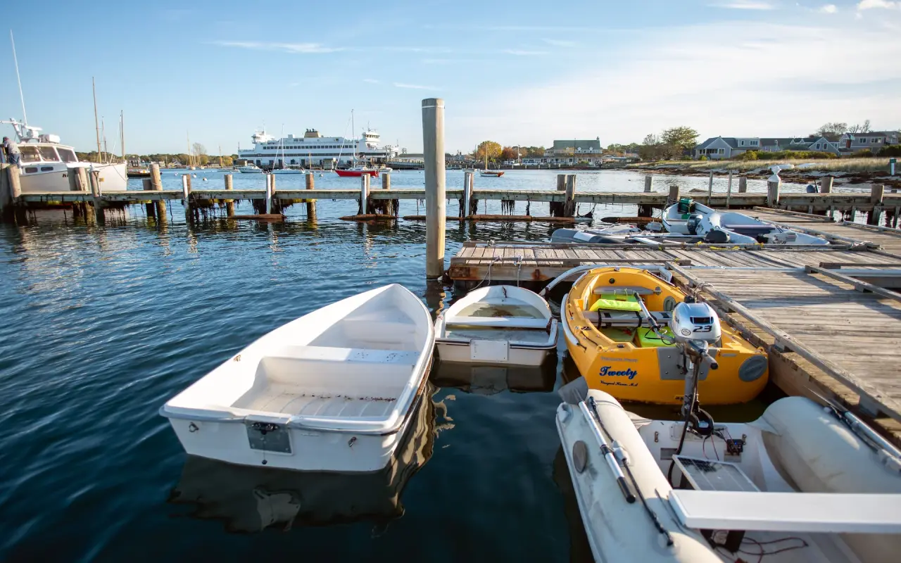 Small boats at a Vineyard Haven dock with the ferry beyond