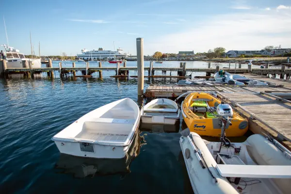 Dinghies at the dock with a ferry in Vineyard Haven harbor
