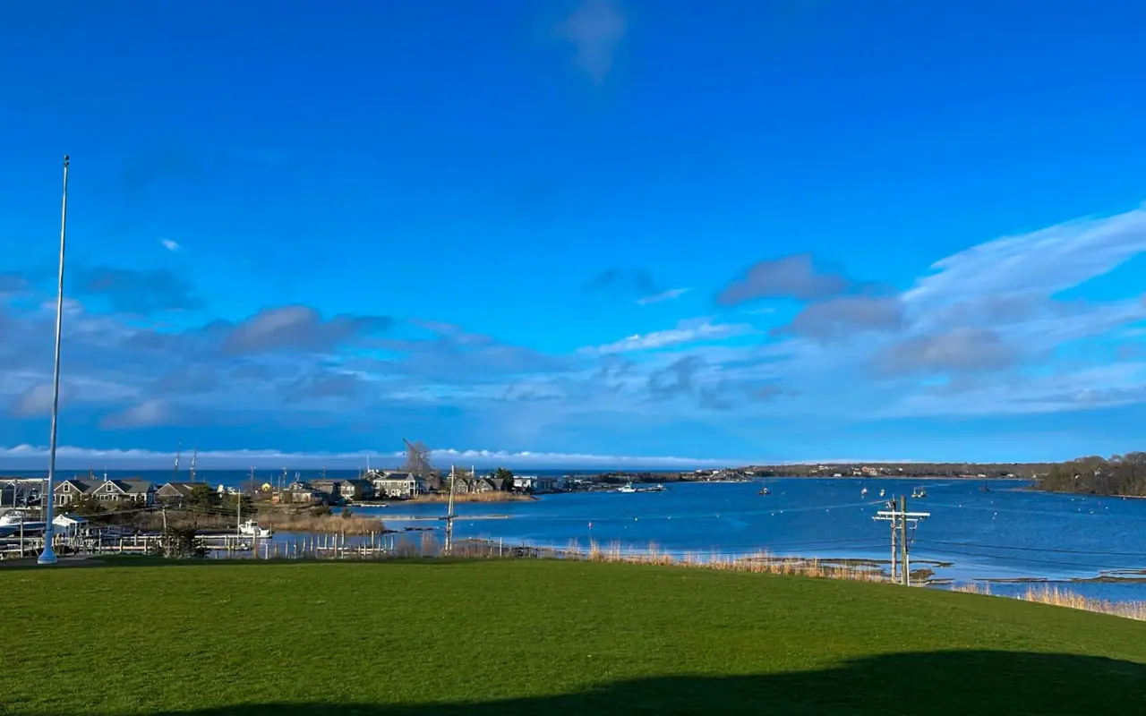 Green lawn at the Martha’s Vineyard Museum overlooking Vineyard Haven harbor under a blue sky