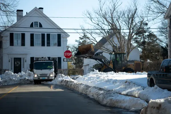 Loader and truck clearing snow on a Vineyard Haven street